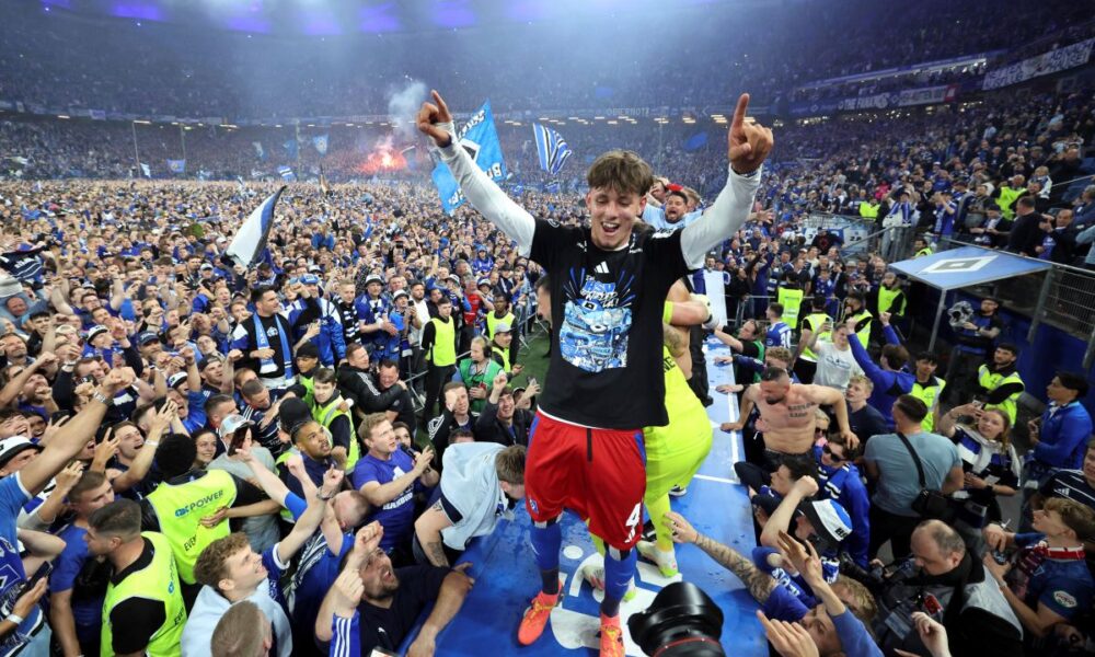 Hamburg's Otto Stange and fans celebrate promotion following a Bundesliga 2 soccer game between Hamburger SV and SSV Ulm 1846 in Hamburg, Germany, Saturday, May 10, 2025. (Christian Charisius/dpa via AP)