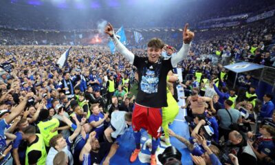 Hamburg's Otto Stange and fans celebrate promotion following a Bundesliga 2 soccer game between Hamburger SV and SSV Ulm 1846 in Hamburg, Germany, Saturday, May 10, 2025. (Christian Charisius/dpa via AP)