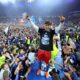 Hamburg's Otto Stange and fans celebrate promotion following a Bundesliga 2 soccer game between Hamburger SV and SSV Ulm 1846 in Hamburg, Germany, Saturday, May 10, 2025. (Christian Charisius/dpa via AP)