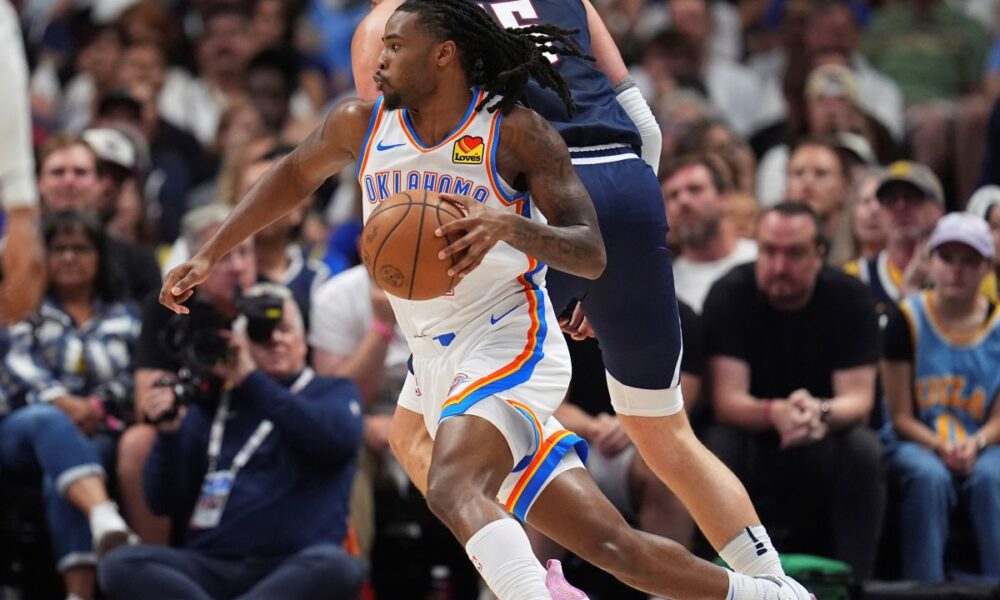 Thunder Nuggets Basketball Oklahoma City Thunder guard Cason Wallace, front, drives past Denver Nuggets center Nikola Jokic, back, in the first half of Game 4 in the Western Conference semifinals of the NBA basketball playoffs Sunday, May 11, 2025, in Denver. (AP Photo/David Zalubowski)