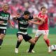 Sporting's Eduardo Quaresma, center, and Benfica's Andreas Schjelderup vie for the ball during a Portuguese league soccer match between SL Benfica and Sporting CP at the Luz stadium in Lisbon, Friday, May 10, 2024. (AP Photo/Armando Franca)