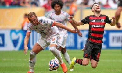 Flamengo's Jorginho, right, falls chased by Bayern Munich's Harry Kane during the Club World Cup round of 16 soccer match between CR Flamengo and Bayern Munich in Miami Gardens, Fla., Sunday, June 29, 2025. (AP Photo/Rebecca Blackwell)