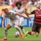 Flamengo's Jorginho, right, falls chased by Bayern Munich's Harry Kane during the Club World Cup round of 16 soccer match between CR Flamengo and Bayern Munich in Miami Gardens, Fla., Sunday, June 29, 2025. (AP Photo/Rebecca Blackwell)