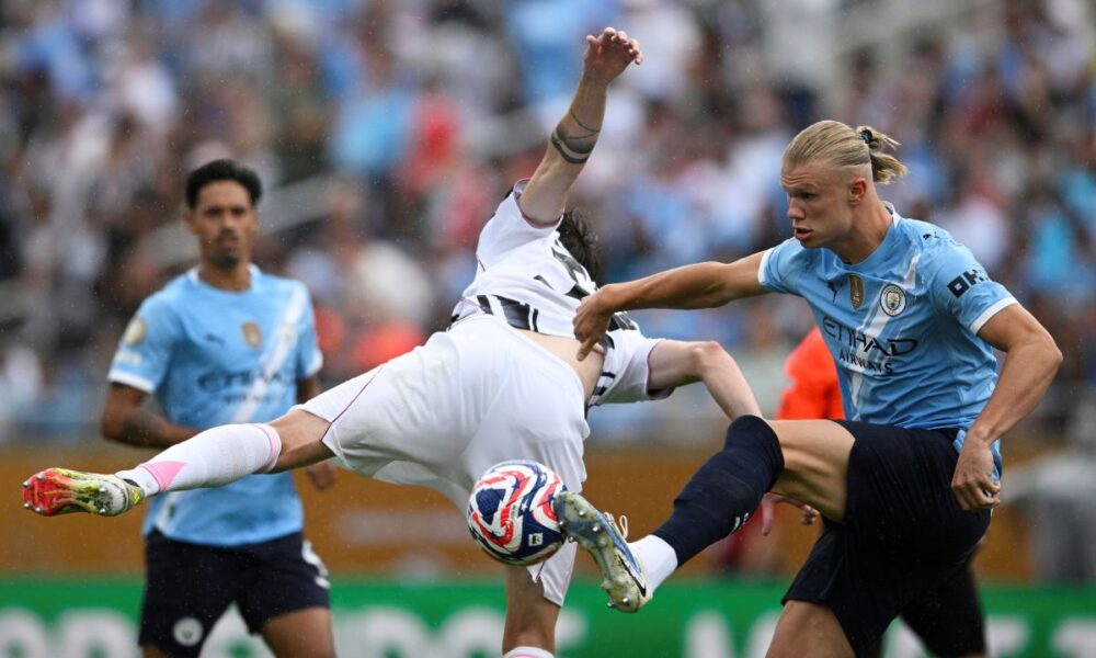 Manchester City's Erling Haaland, right, and Juventus' Nicolo Savona battle for the ball during the Club World Cup Group G soccer match between Juventus and Manchester City in Orlando, Fla., Thursday, June 26, 2025. (AP Photo/Phelan Ebenhack)