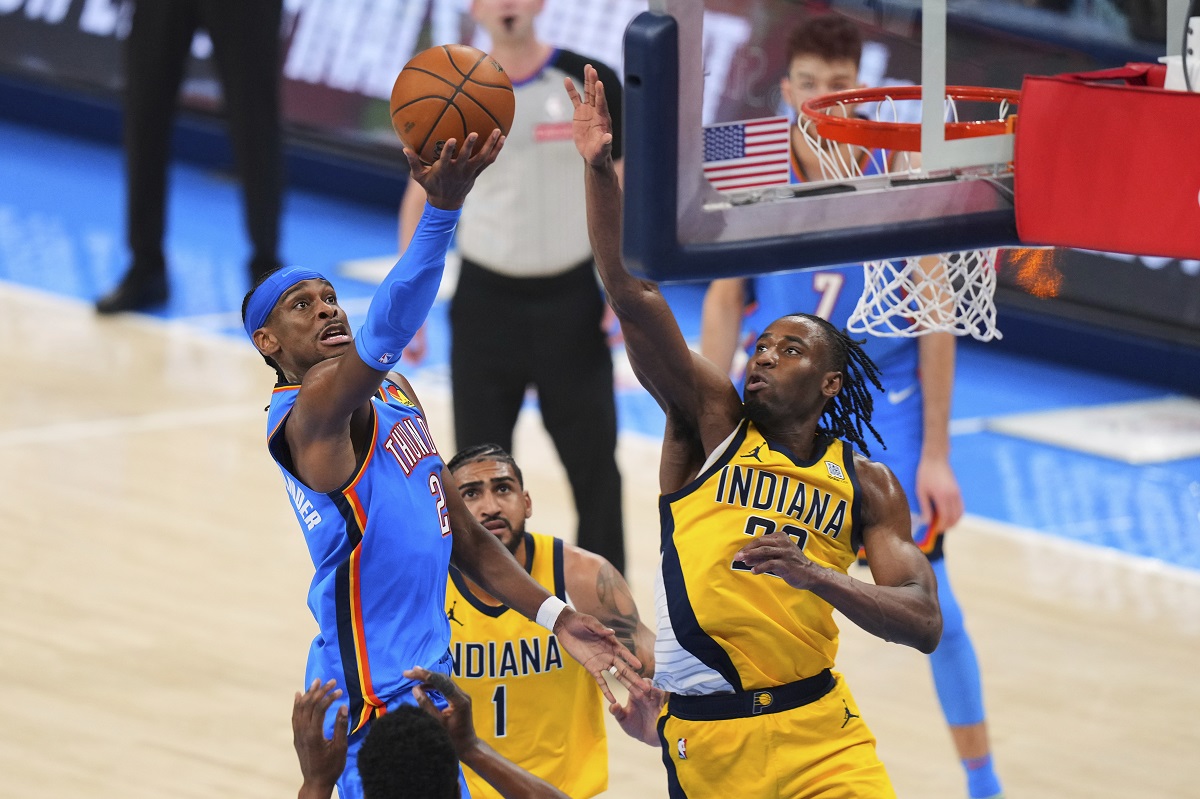 Oklahoma City Thunder guard Shai Gilgeous-Alexander (2) shoots against Indiana Pacers forward Aaron Nesmith (23) during the second half of Game 2 of the NBA Finals basketball series Sunday, June 8, 2025, in Oklahoma City. (AP Photo/Kyle Phillips)