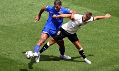 Germany's Niclas Fuellkrug, right, and France's Loic Bade, left, challenge for the ball during the Nations League third place soccer match between Germany and France in Stuttgart, Germany, Sunday, June 8, 2025. (Marijan Murat/dpa via AP)