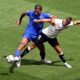 Germany's Niclas Fuellkrug, right, and France's Loic Bade, left, challenge for the ball during the Nations League third place soccer match between Germany and France in Stuttgart, Germany, Sunday, June 8, 2025. (Marijan Murat/dpa via AP)