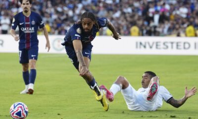 Paris Saint-Germain's Bradley Barcola, center, and Botafogo's Allan vie for the ball during the Club World Cup group B soccer match between PSG and Botafogo in Pasadena, Calif., Thursday, June 19, 2025. (AP Photo/Jae C. Hong)