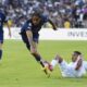 Paris Saint-Germain's Bradley Barcola, center, and Botafogo's Allan vie for the ball during the Club World Cup group B soccer match between PSG and Botafogo in Pasadena, Calif., Thursday, June 19, 2025. (AP Photo/Jae C. Hong)