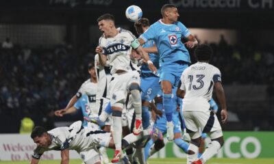 Georgios Giakoumakis of Mexico's Cruz Azul, top right, and Ranko Veselinovic of Canada's Vancouver Whitecaps vie for the ball during the CONCACAF Champions Cup final soccer match in Mexico City, Sunday, June 1, 2025. (AP Photo/Fernando Llano)