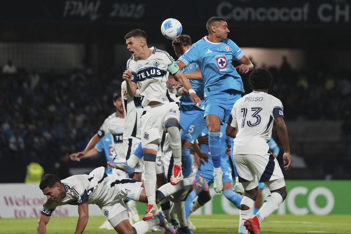 Georgios Giakoumakis of Mexico's Cruz Azul, top right, and Ranko Veselinovic of Canada's Vancouver Whitecaps vie for the ball during the CONCACAF Champions Cup final soccer match in Mexico City, Sunday, June 1, 2025. (AP Photo/Fernando Llano)