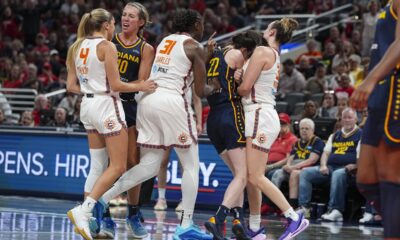 Indiana Fever guard Caitlin Clark (22) is hit by Connecticut Sun guard Marina Mabrey (3) during a scuffle in the second half of a WNBA basketball game in Indianapolis, Tuesday, June 17, 2025. (AP Photo/Michael Conroy)