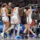 Indiana Fever guard Caitlin Clark (22) is hit by Connecticut Sun guard Marina Mabrey (3) during a scuffle in the second half of a WNBA basketball game in Indianapolis, Tuesday, June 17, 2025. (AP Photo/Michael Conroy)