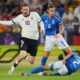 Germany's Nick Woltemade, left, duels for the ball with Italy's Daniele Ghilardi, top right, and Italy's Mattia Zanotti during a quarter final soccer match between Germany and Italy at the European U-21 Championship at the DAC Arena in Dunajska Streda, Slovakia, Sunday, June 22, 2025. (AP Photo/Petr David Josek)