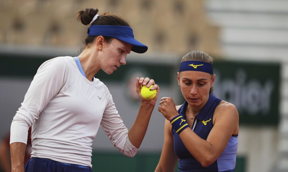 Kazakhstan's Anna Danilina, left, and Serbia's Aleksandra Krunic talk as they play against Norway's Ulrikke Eikeri and Japan's Eri Hozumi during their women's doubles semifinal match of the French Tennis Open at the Roland-Garros stadium in Paris, Friday, June 6, 2025. (AP Photo/Lindsey Wasson)