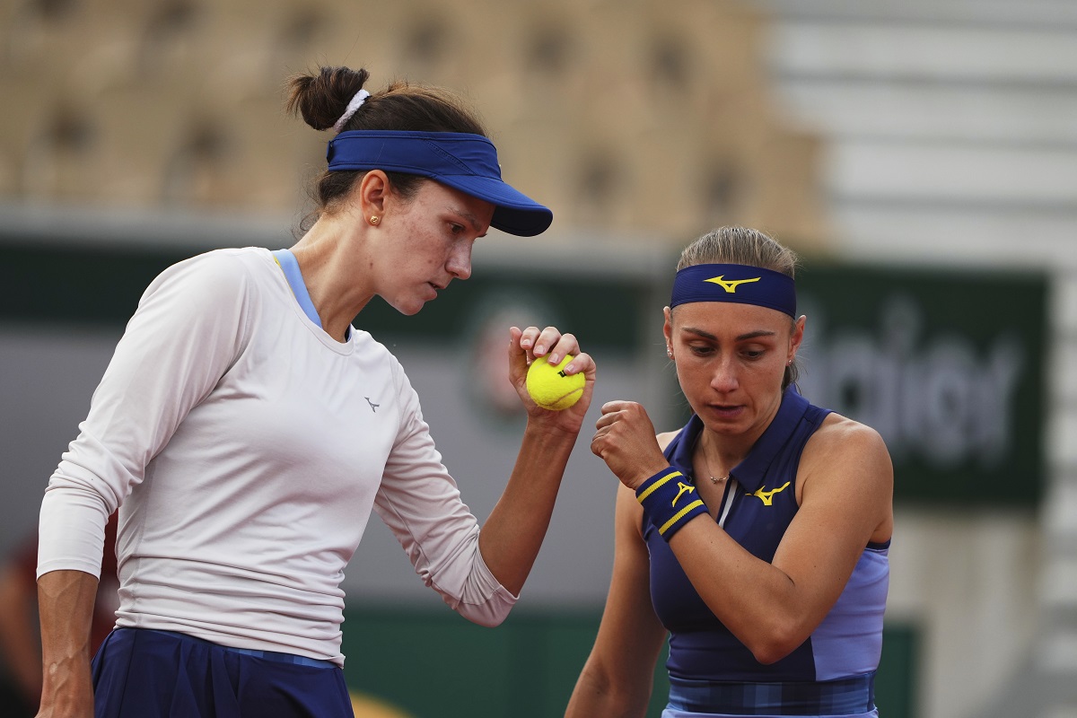 Kazakhstan's Anna Danilina, left, and Serbia's Aleksandra Krunic talk as they play against Norway's Ulrikke Eikeri and Japan's Eri Hozumi during their women's doubles semifinal match of the French Tennis Open at the Roland-Garros stadium in Paris, Friday, June 6, 2025. (AP Photo/Lindsey Wasson)