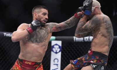 Ilia Topuria, left, fights Charles Oliveira in a lightweight title fight at UFC 317, Saturday, June 28, 2025, in Las Vegas. (AP Photo/John Locher)