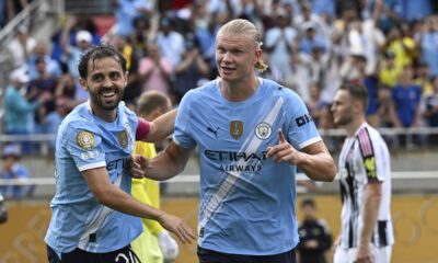 Manchester City's Erling Haaland, right, celebrates with teammate Bernardo Silva after scoring his side's third goal during the Club World Cup Group G soccer match between Juventus and Manchester City in Orlando, Fla., Thursday, June 26, 2025. (AP Photo/Phelan Ebenhack)