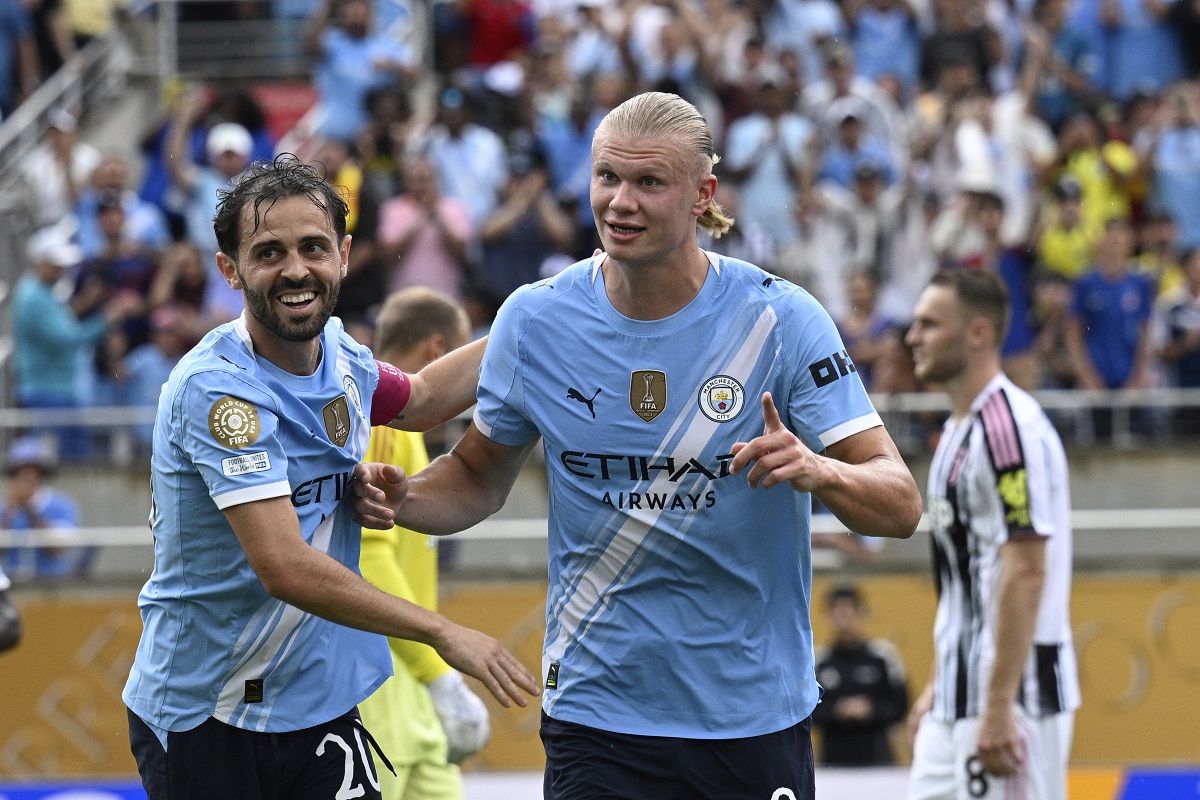 Manchester City's Erling Haaland, right, celebrates with teammate Bernardo Silva after scoring his side's third goal during the Club World Cup Group G soccer match between Juventus and Manchester City in Orlando, Fla., Thursday, June 26, 2025. (AP Photo/Phelan Ebenhack)