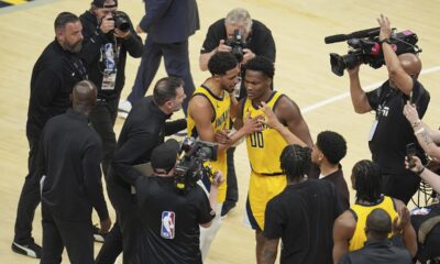 Indiana Pacers guard Bennedict Mathurin (00) and Indiana Pacers guard Tyrese Haliburton celebrate after Game 3 of the NBA Finals basketball series against the Oklahoma City Thunder, Wednesday, June 11, 2025, in Indianapolis. (AP Photo/Michael Conroy)