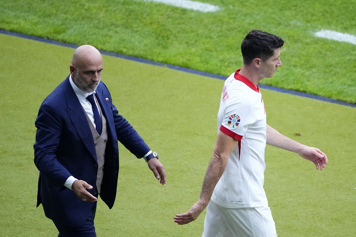 FILE - Poland's Robert Lewandowski, right, walks by Poland' head coach Michal Probierz, left, during a Group D match between Poland and Austria at the Euro 2024 soccer tournament in Berlin, Germany, Friday, June 21, 2024. (AP Photo/Petr Josek, File)