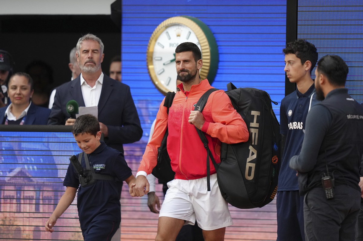 Serbia's Novak Djokovic enters the court for the quarterfinal match of the French Tennis Open against Germany's Alexander Zverev at the Roland-Garros stadium in Paris, Wednesday, June 4, 2025. (AP Photo/Aurelien Morissard)
