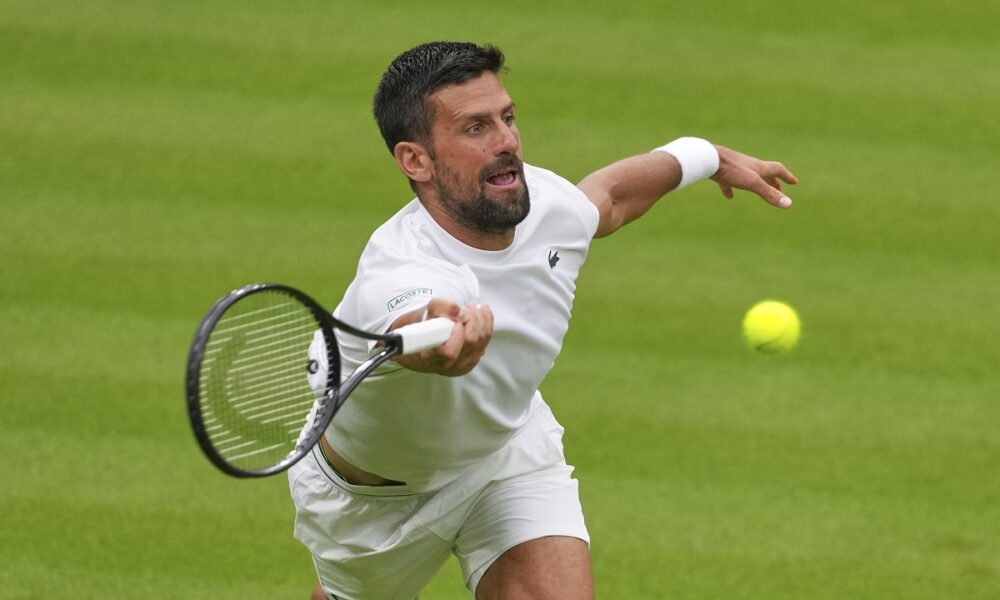 Novak Djokovic of Serbia plays a return to Carlos Alcaraz of Spain during a practice session on Centre Court at the All England Lawn Tennis and Croquet Club, ahead of the Wimbledon Championships in London, Thursday, June 26, 2025. (AP Photo/Kirsty Wigglesworth)