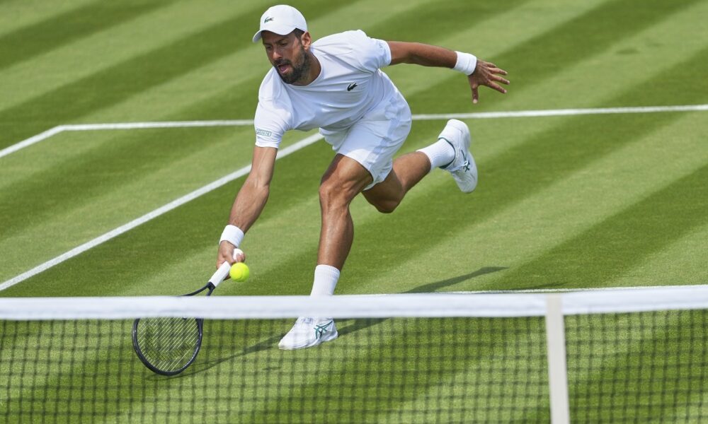 Novak Djokovic of Serbia plays a return during a practice session at the All England Lawn Tennis and Croquet Club, ahead of the Wimbledon Championships in London, Wednesday, June 25, 2025. (AP Photo/Kirsty Wigglesworth)
