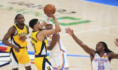 Indiana Pacers guard Tyrese Haliburton (0) shoots a 3-pointer against Oklahoma City Thunder guard Cason Wallace (22) during the second half of Game 1 of the NBA Finals basketball series Thursday, June 5, 2025, in Oklahoma City. (AP Photo/Julio Cortez)