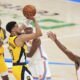 Indiana Pacers guard Tyrese Haliburton (0) shoots a 3-pointer against Oklahoma City Thunder guard Cason Wallace (22) during the second half of Game 1 of the NBA Finals basketball series Thursday, June 5, 2025, in Oklahoma City. (AP Photo/Julio Cortez)