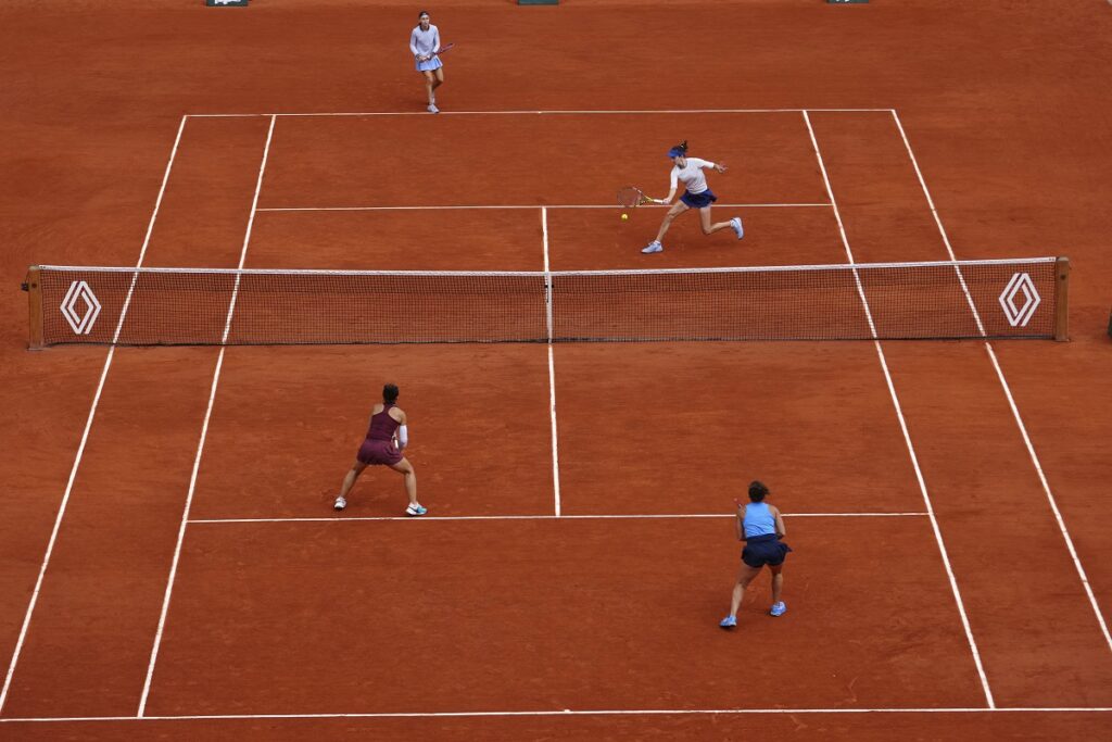 Kazakhstan Anna Danilina, top right, and Serbia's Aleksandra Krunic play a shot against Italy's Jasmine Paolini, bottom right, and Sara Errani during their women's doubles final match of the French Tennis Open at the Roland-Garros stadium in Paris, Sunday, June 8, 2025. (AP Photo/Thibault Camus)