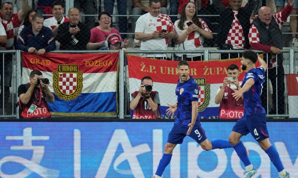Croatia's Andrej Kramaric, left, celebrates with teammates after scoring the opening goal during a World Cup 2026 group L qualifying soccer match between Croatia and Czech Republic at the Opus Arena in Osijek, Croatia, Monday, June 9, 2025. (AP Photo/Darko Bandic)