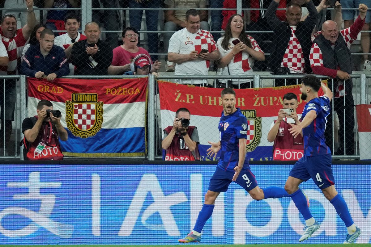 Croatia's Andrej Kramaric, left, celebrates with teammates after scoring the opening goal during a World Cup 2026 group L qualifying soccer match between Croatia and Czech Republic at the Opus Arena in Osijek, Croatia, Monday, June 9, 2025. (AP Photo/Darko Bandic)