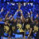 Oklahoma City Thunder guard Shai Gilgeous-Alexander, center, holds up the MVP trophy as he celebrates with his team after they won the NBA basketball championship with a Game 7 victory against the Indiana Pacers Sunday, June 22, 2025, in Oklahoma City. (AP Photo/Julio Cortez)