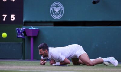 Serbia's Novak Djokovic reacts after slipping and falling when attempting a return to Italy's Flavio Cobolli during a quarterfinal men's singles match at the Wimbledon Tennis Championships in London, Wednesday, July 9, 2025. (AP Photo/Kin Cheung)
