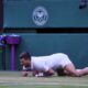 Serbia's Novak Djokovic reacts after slipping and falling when attempting a return to Italy's Flavio Cobolli during a quarterfinal men's singles match at the Wimbledon Tennis Championships in London, Wednesday, July 9, 2025. (AP Photo/Kin Cheung)