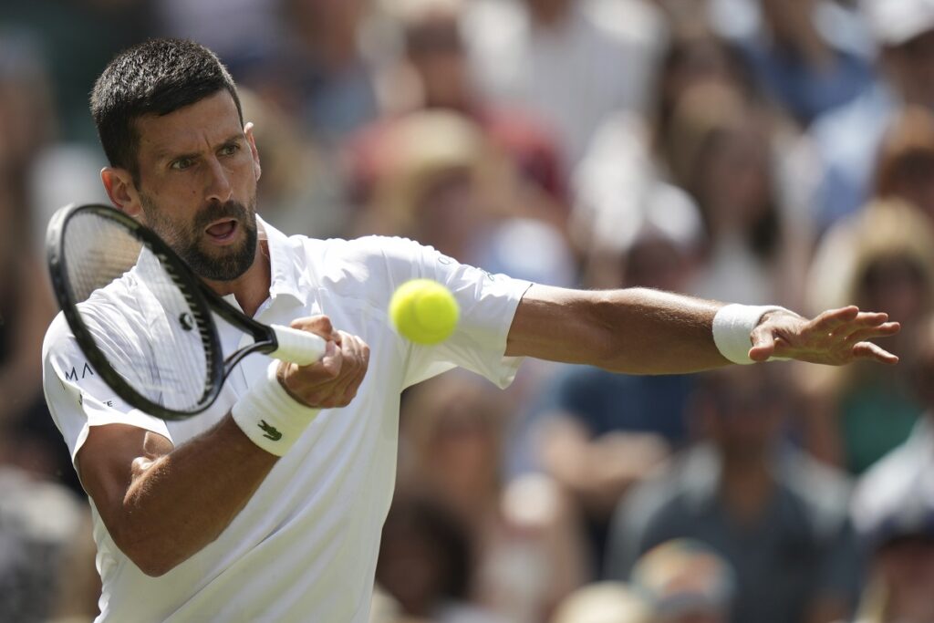Novak Djokovic of Serbia returns to Daniel Evans of Britain during their second round men's singles match at the Wimbledon Tennis Championships in London, Thursday, July 3, 2025. (AP Photo/Alastair Grant)