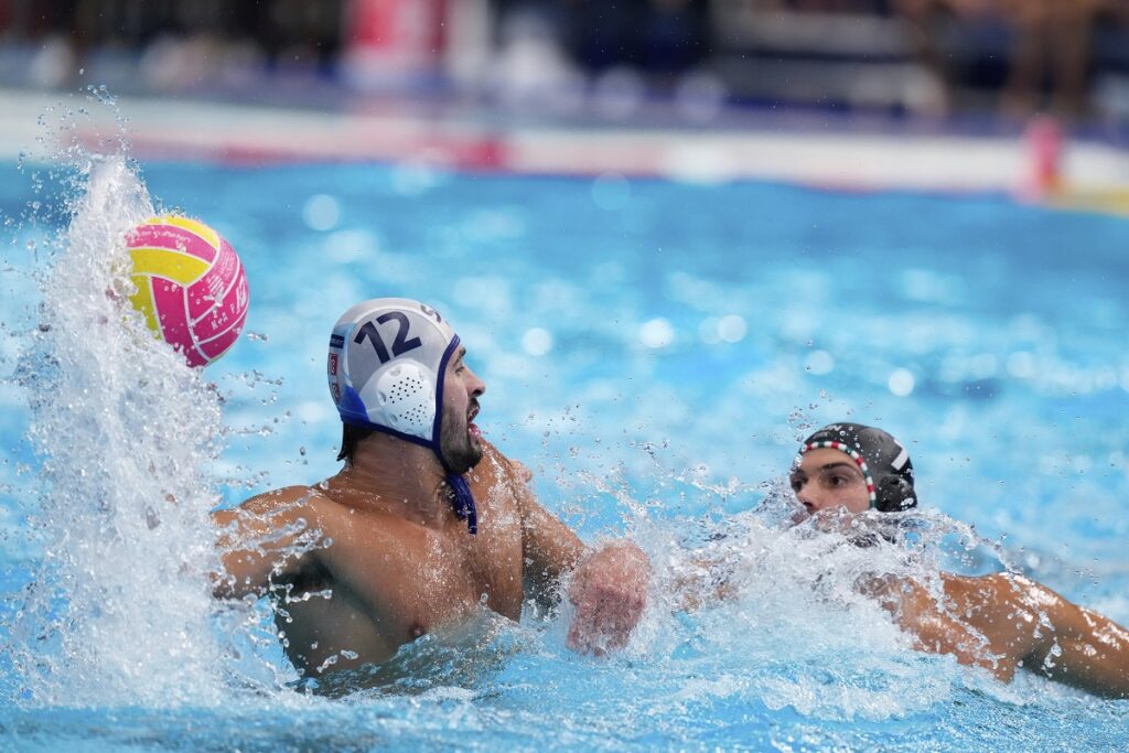 Serbia's Viktor Rasovic, left, attempts to score against Hungary's Gergo Janos Fekete during a men's water polo semifinal match between Serbia and Hungary at the World Aquatics Championships in Singapore, Tuesday, July 22, 2025. (AP Photo/Vincent Thian)