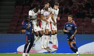 AC Milan's players in white blocks the ball during a friendly match against Arsenal for the Singapore Festival of Football at the National Stadium in Singapore, Wednesday, July 23, 2025. (AP Photo/Vincent Thian)