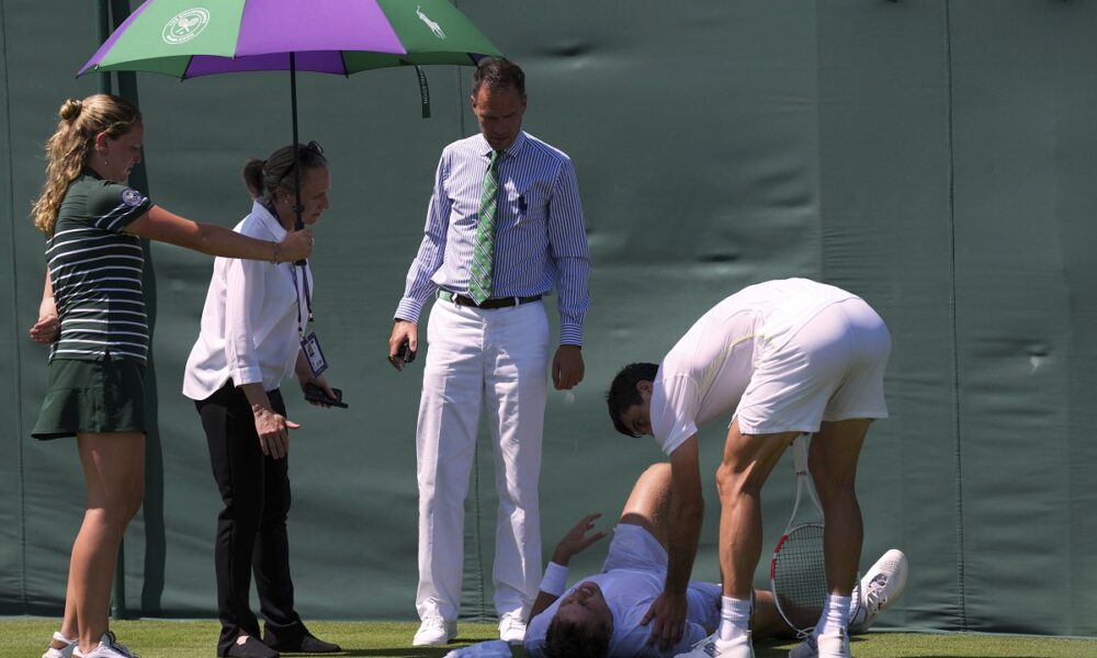 Hamad Medjedovic of Serbia lies injured on the court after he ran into a board during his first round men's singles match against Sebastian Ofner of Austria at the Wimbledon Tennis Championships in London, Tuesday, July 1, 2025.(AP Photo/Dave Shopland)