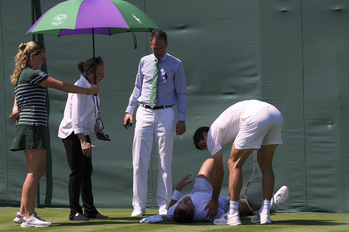 Hamad Medjedovic of Serbia lies injured on the court after he ran into a board during his first round men's singles match against Sebastian Ofner of Austria at the Wimbledon Tennis Championships in London, Tuesday, July 1, 2025.(AP Photo/Dave Shopland)