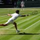 Carlos Alcaraz of Spain returns the ball to Taylor Fritz of the U.S. during the men's semifinal singles match at the Wimbledon Tennis Championships in London, Friday, July 11, 2025.(AP Photo/Kirsty Wigglesworth)