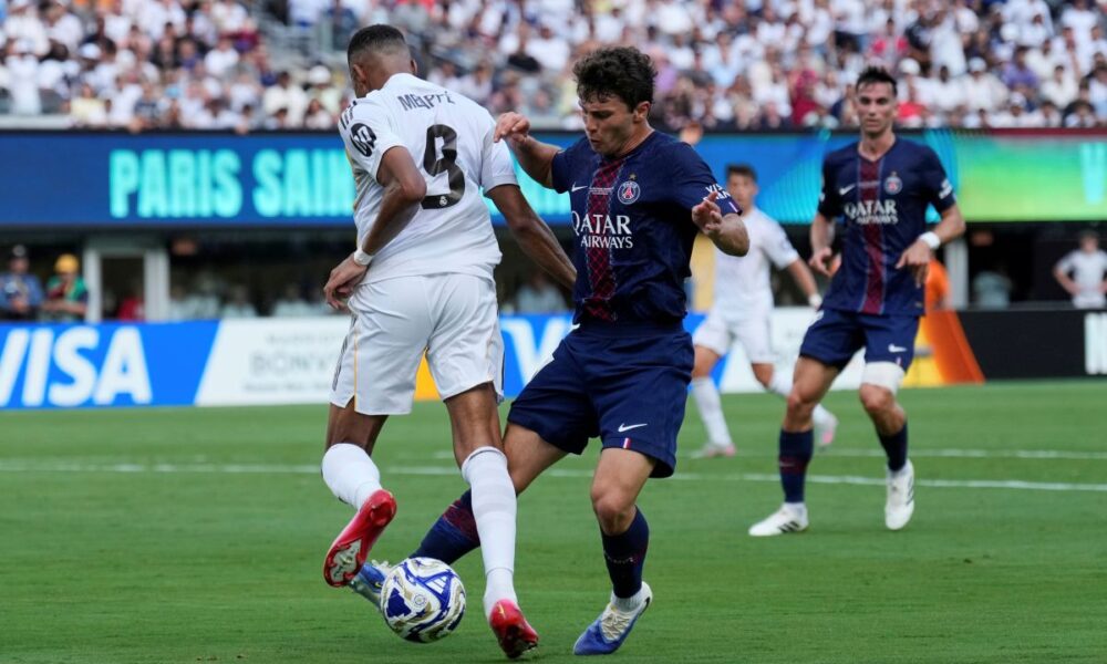 Paris Saint-Germain's Joao Neves (87) tackles Real Madrid's Kylian Mbappe (9) during the Club World Cup semifinal soccer match between PSG and Real Madrid in East Rutherford, N.J., Wednesday, July 9, 2025. (AP Photo/Seth Wenig)