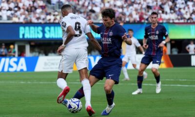 Paris Saint-Germain's Joao Neves (87) tackles Real Madrid's Kylian Mbappe (9) during the Club World Cup semifinal soccer match between PSG and Real Madrid in East Rutherford, N.J., Wednesday, July 9, 2025. (AP Photo/Seth Wenig)