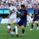 Paris Saint-Germain's Joao Neves (87) tackles Real Madrid's Kylian Mbappe (9) during the Club World Cup semifinal soccer match between PSG and Real Madrid in East Rutherford, N.J., Wednesday, July 9, 2025. (AP Photo/Seth Wenig)
