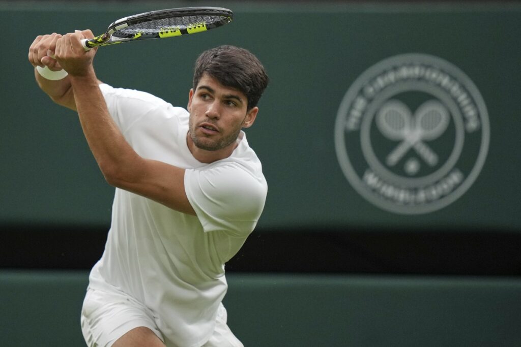 Spain's Carlos Alcaraz returns to Russia's Andrey Rublev during a fourth round men's singles match at the Wimbledon Tennis Championships in London, Sunday, July 6, 2025. (AP Photo/Alastair Grant)