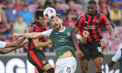 Hibernians' Jack Iredale, Hibernian, center, Midtjylland's Friday Etim, right, and Lee Han-beom, of South Korean, battle for the ball during the Europa League qualifying soccer match between FC Midtjylland and Hibernian at MCH Arena in Herning, Denmark, Thursday, July 24, 2025. (Bo Amstrup/Ritzau Scanpix via AP)