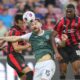 Hibernians' Jack Iredale, Hibernian, center, Midtjylland's Friday Etim, right, and Lee Han-beom, of South Korean, battle for the ball during the Europa League qualifying soccer match between FC Midtjylland and Hibernian at MCH Arena in Herning, Denmark, Thursday, July 24, 2025. (Bo Amstrup/Ritzau Scanpix via AP)