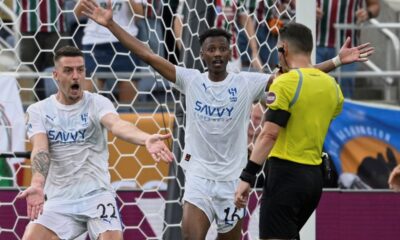 Al Hilal's Sergej Milinkovic-Savic, left, and Al Hilal's Nasser Al-Dawsari complain to the referee during the Club World Cup quarterfinal soccer match between Fluminense and Al Hilal in Orlando, Fla., Friday, July 4, 2025. (AP Photo/Phelan M. Ebenhack)