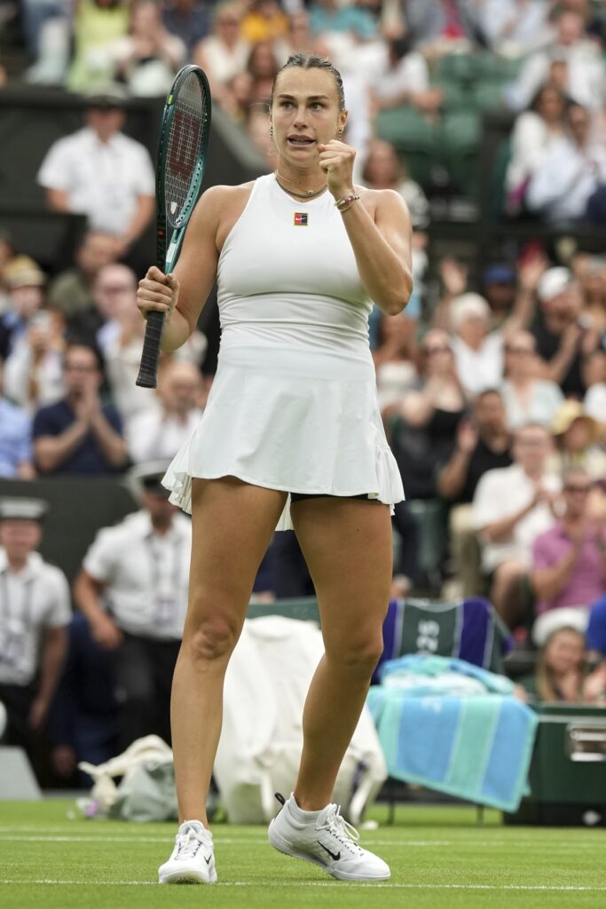 Aryna Sabalenka of Belarus celebrates after beating Belgium's Elise Mertens in a fourth round women's singles match at the Wimbledon Tennis Championships in London, Sunday, July 6, 2025. (AP Photo/Alastair Grant)